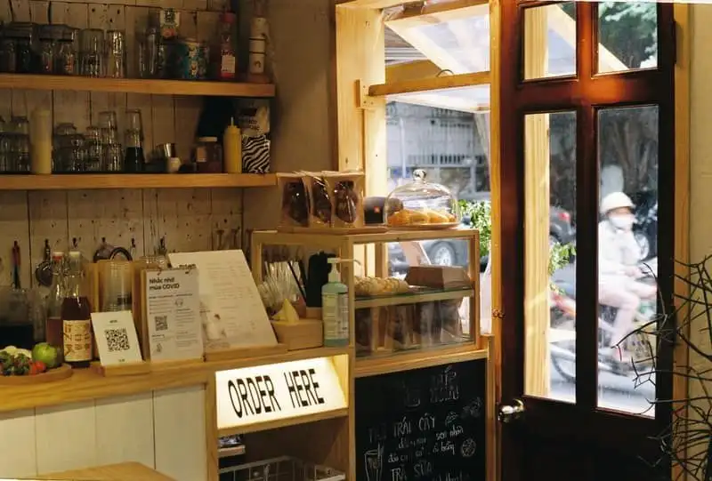 The counter and pastry case inside a small bakery, with no one in the frame